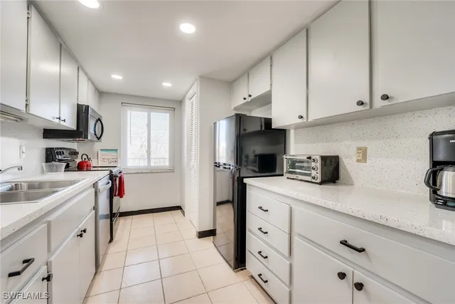 a spacious bedroom with a bed and a lamp