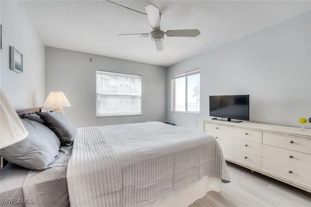 a bedroom with a large bed and a flat screen tv