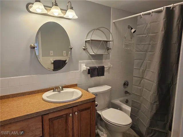 a bedroom with furniture and a flat screen tv