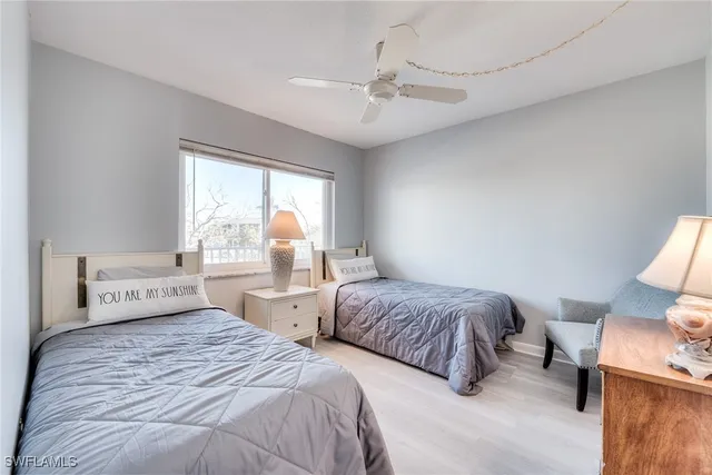 a bedroom with two beds and painting on the wall