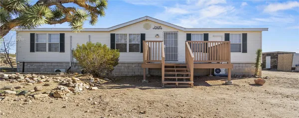 a view of a house with a yard and wooden fence