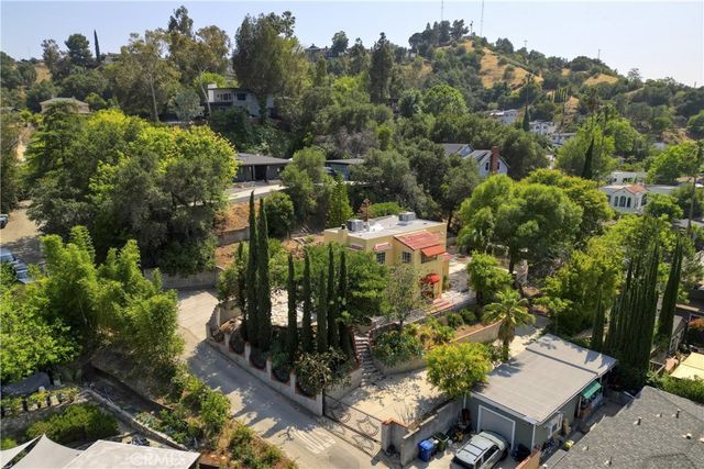 an aerial view of a house with a yard