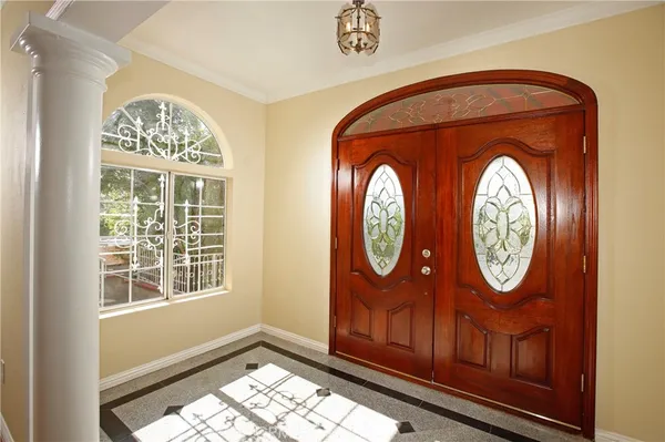 a area with a clock on wall and a large window