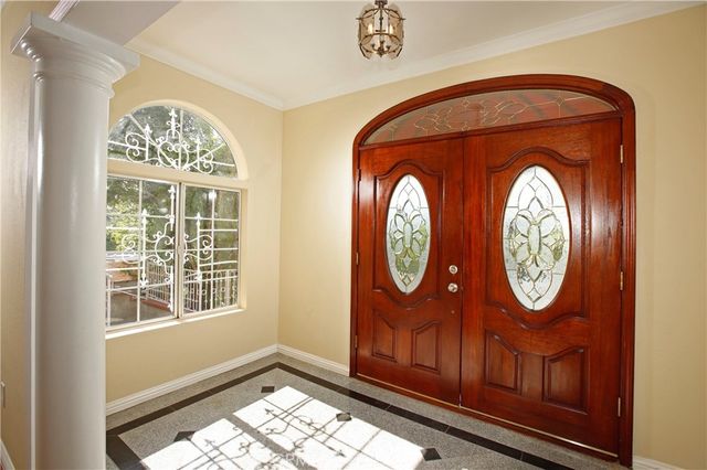 a area with a clock on wall and a large window