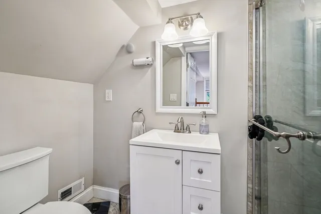 a bathroom with a sink a toilet and a mirror