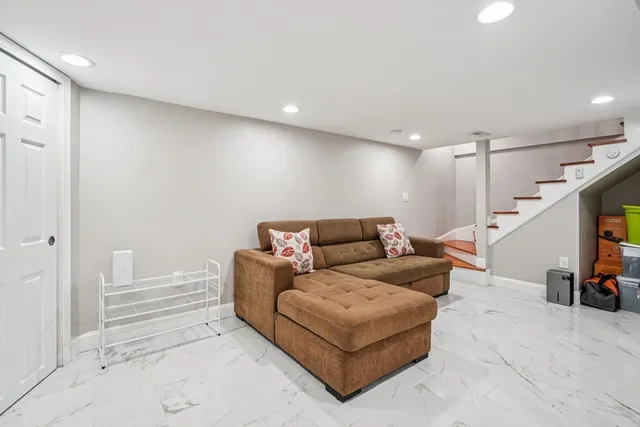 a living room with furniture and a lamp