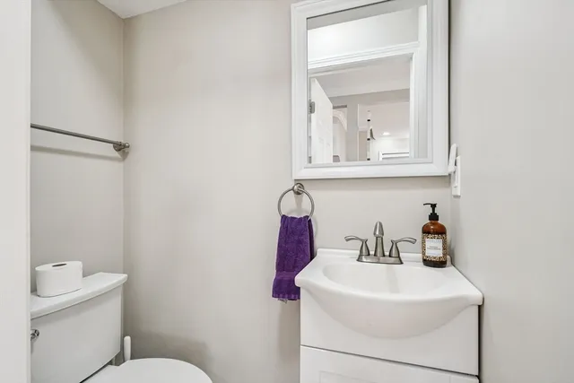 a bathroom with a sink toilet and mirror