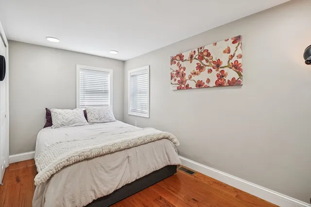 a bedroom with a large bed and a window