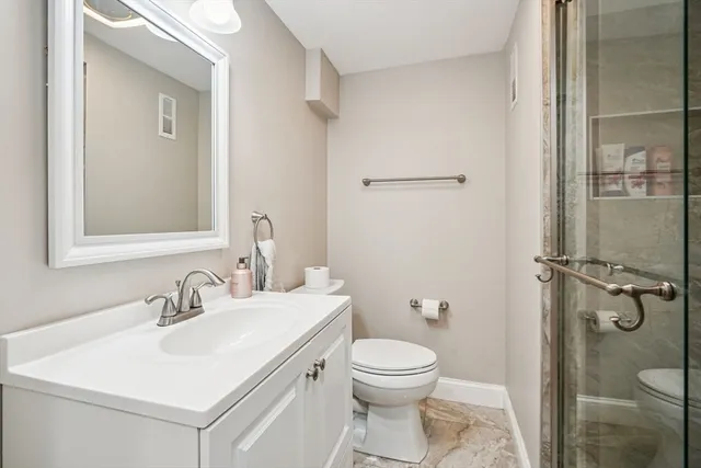 a bathroom with a sink toilet and shower