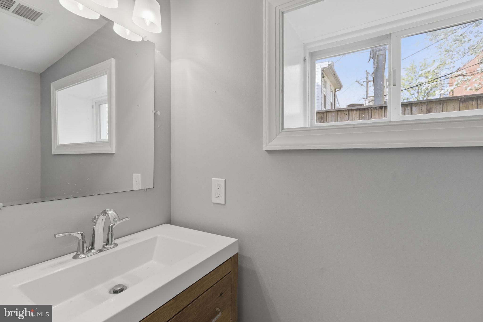 513 Scott Street Baltimore, MD 21230 - Photo 5 of 14 a bathroom with a sink vanity and a mirror