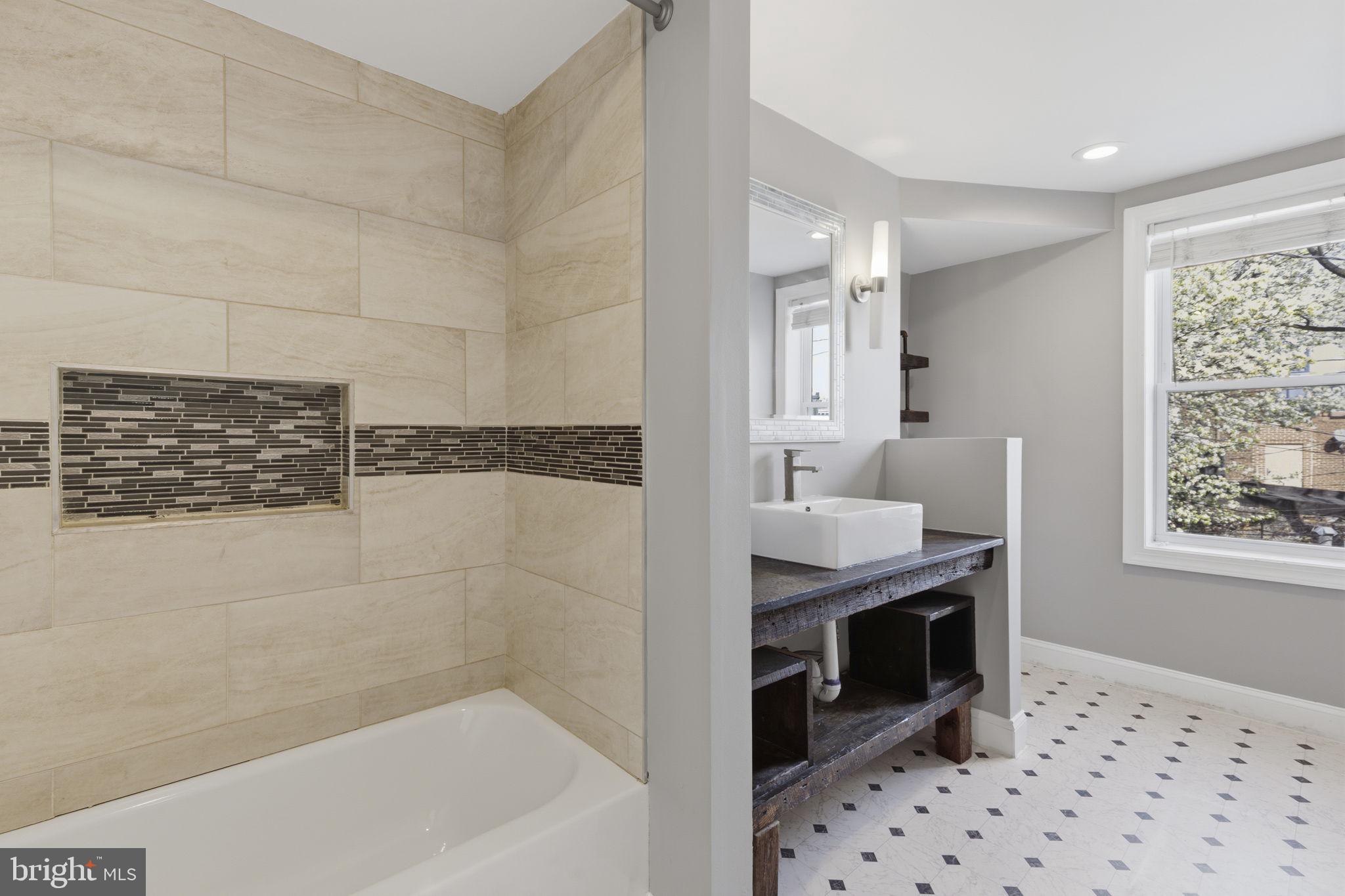 513 Scott Street Baltimore, MD 21230 - Photo 10 of 14 a bathroom with a granite countertop sink a vanity and bathtub
