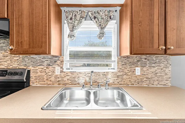 a view of kitchen sink window and cabinets