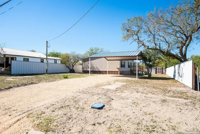 a swimming pool with outdoor seating and yard