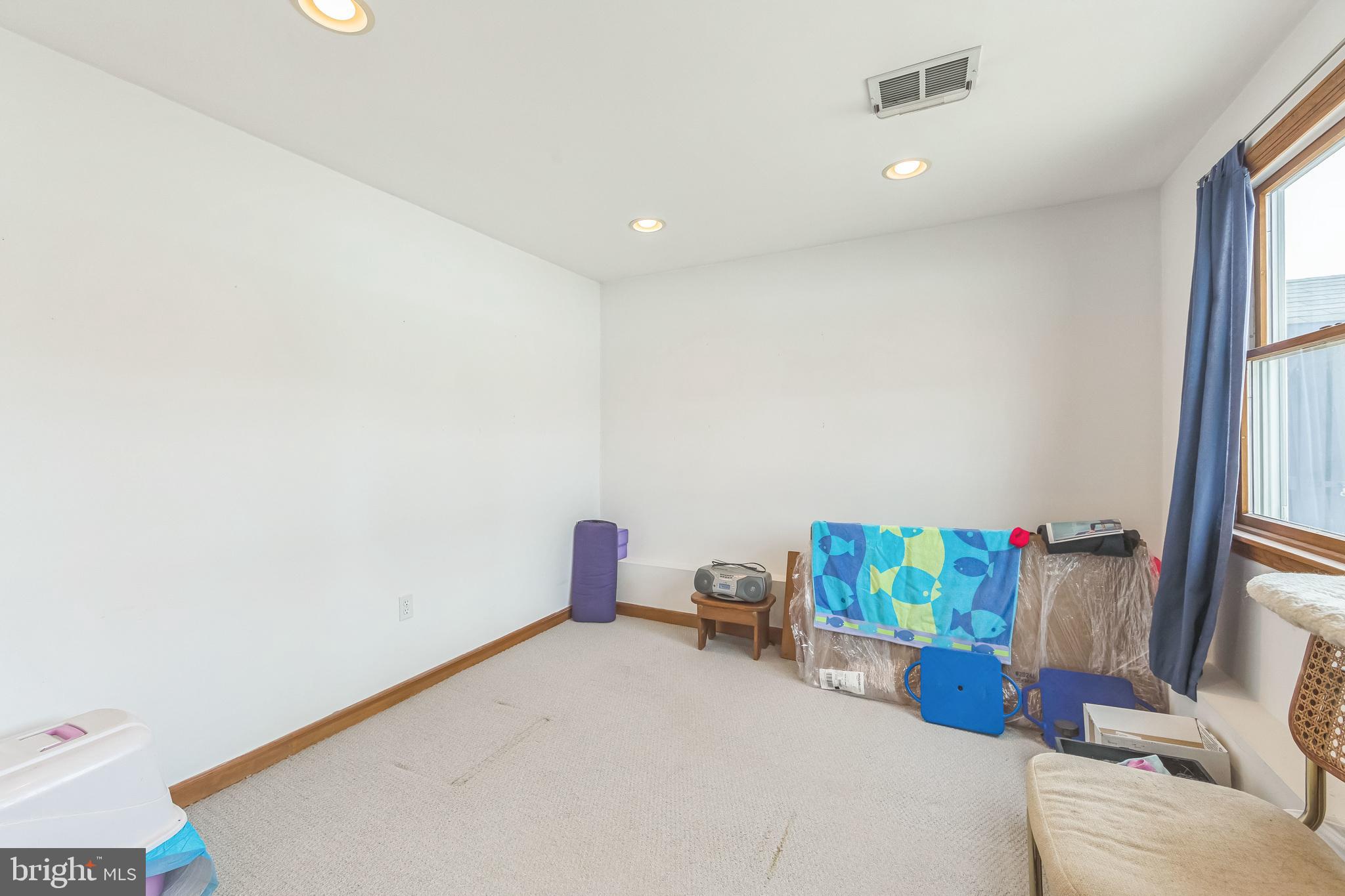 864 Estates Boulevard Hamilton, NJ 08690 - Photo 7 of 15 a bedroom with a bed and a window
