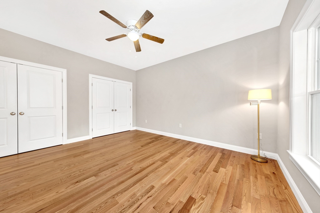 29 Willow Pond Circle, Unit 29 Medway, MA 02053 - Photo 21 of 38 an empty room with wooden floor and a ceiling fan