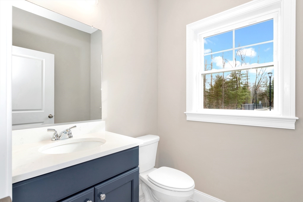 29 Willow Pond Circle, Unit 29 Medway, MA 02053 - Photo 6 of 38 a bathroom with a sink a toilet a window and mirror