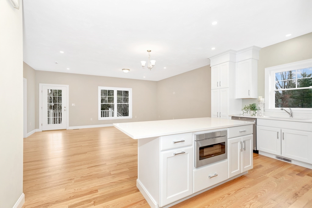 29 Willow Pond Circle, Unit 29 Medway, MA 02053 - Photo 7 of 38 a kitchen with stainless steel appliances white cabinets and wooden floor