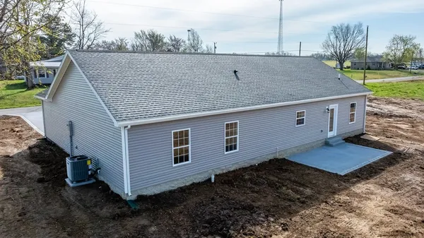 an aerial view of a house with a yard basket ball court and outdoor seating