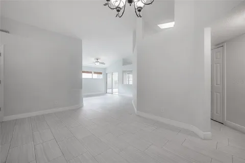 a large kitchen with stainless steel appliances a stove a refrigerator and a view of living room