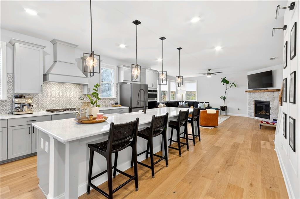 3481 Jasmine Way Atlanta, GA 30331 - Photo 12 of 41 a kitchen with stainless steel appliances kitchen island granite countertop a table chairs sink and cabinets