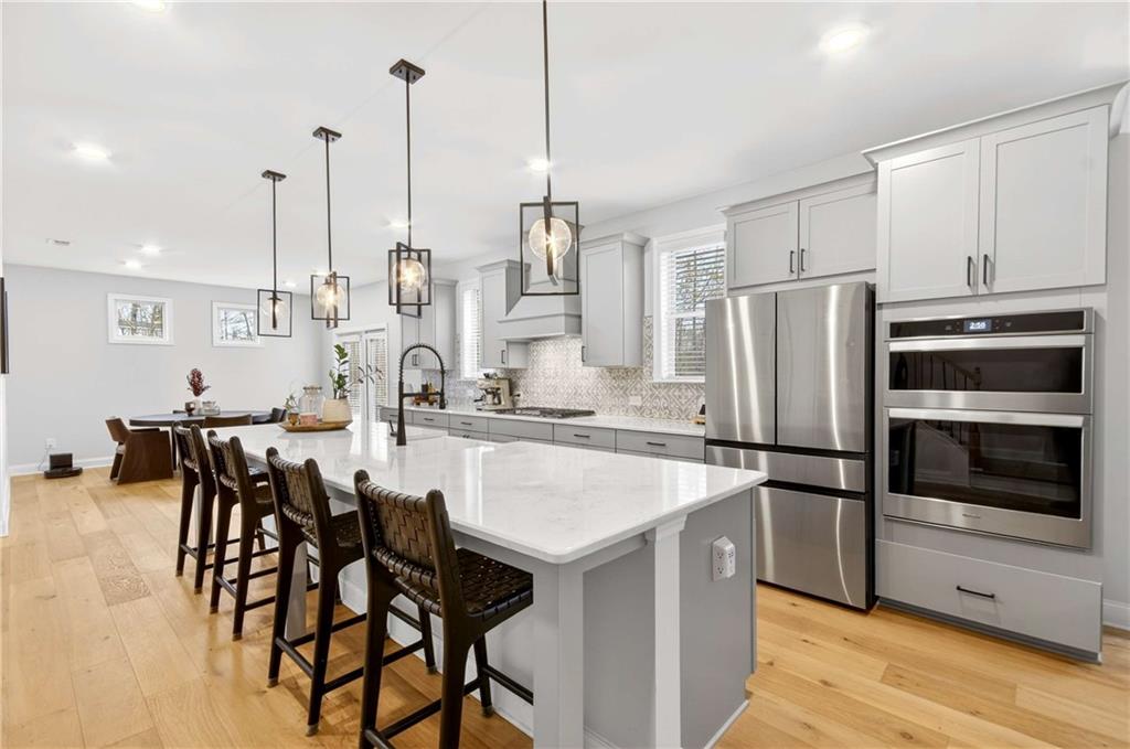 3481 Jasmine Way Atlanta, GA 30331 - Photo 13 of 41 a kitchen with a table chairs stainless steel appliances and cabinets