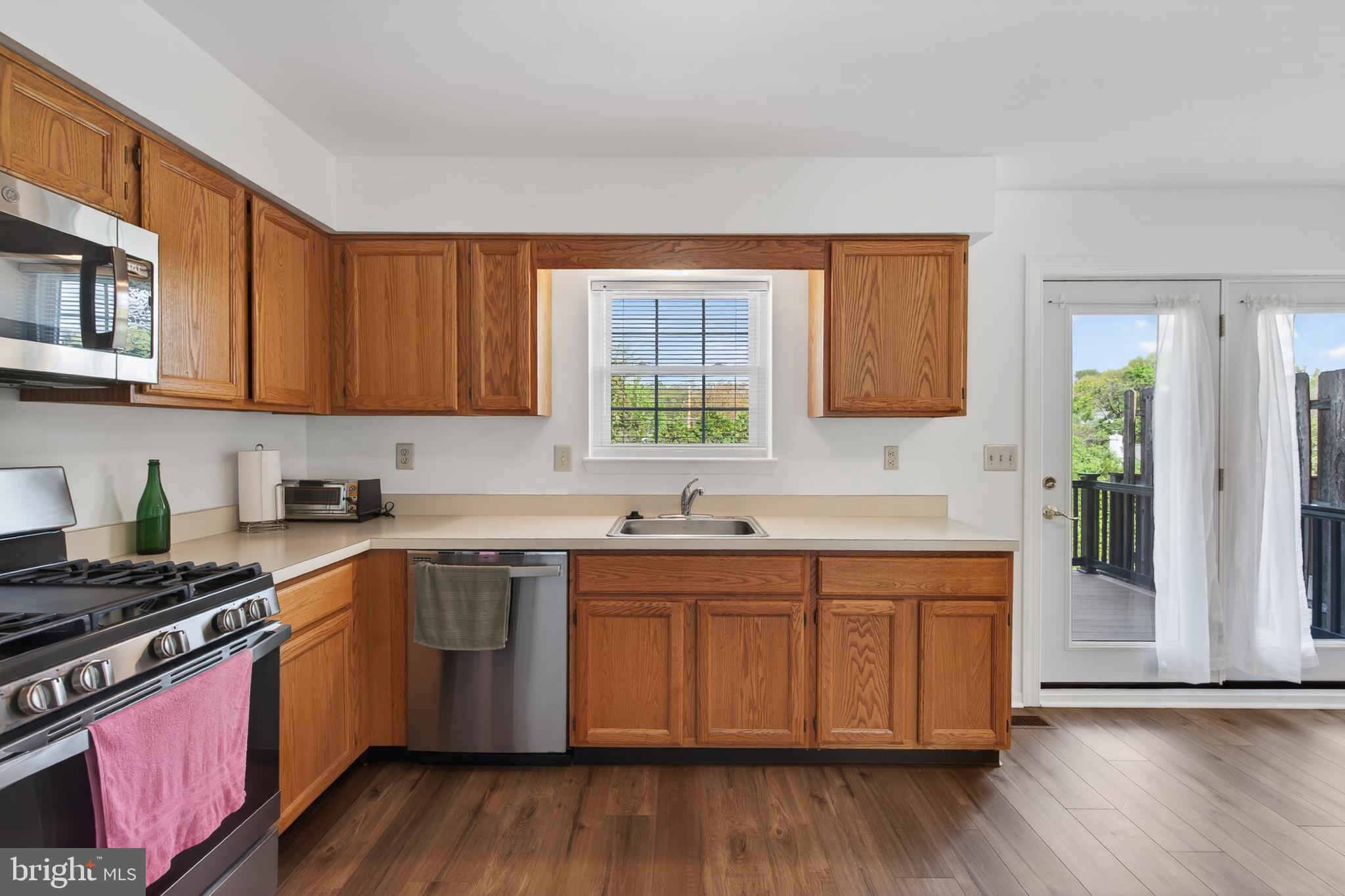 122 Longford Road West Chester, PA 19380 - Photo 11 of 39 a kitchen with stainless steel appliances granite countertop wooden cabinets a sink and dishwasher a stove with wooden floor