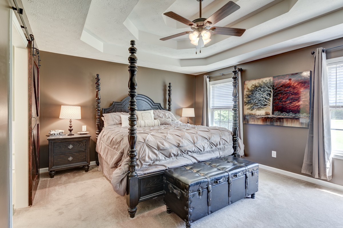 3011 Tyree Springs Road Hendersonville, TN 37075 - Photo 14 of 43 a bed room with a bed and a chandelier