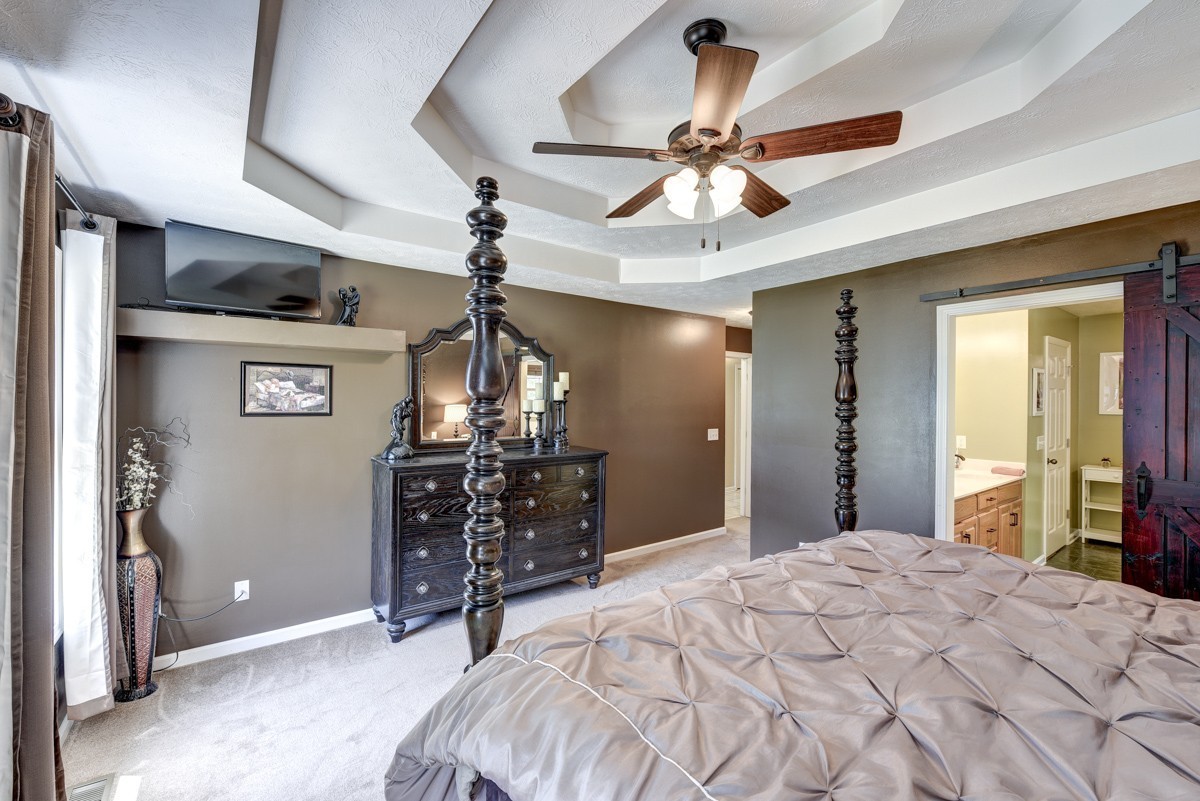 3011 Tyree Springs Road Hendersonville, TN 37075 - Photo 16 of 43 a bedroom with a bed and a chandelier