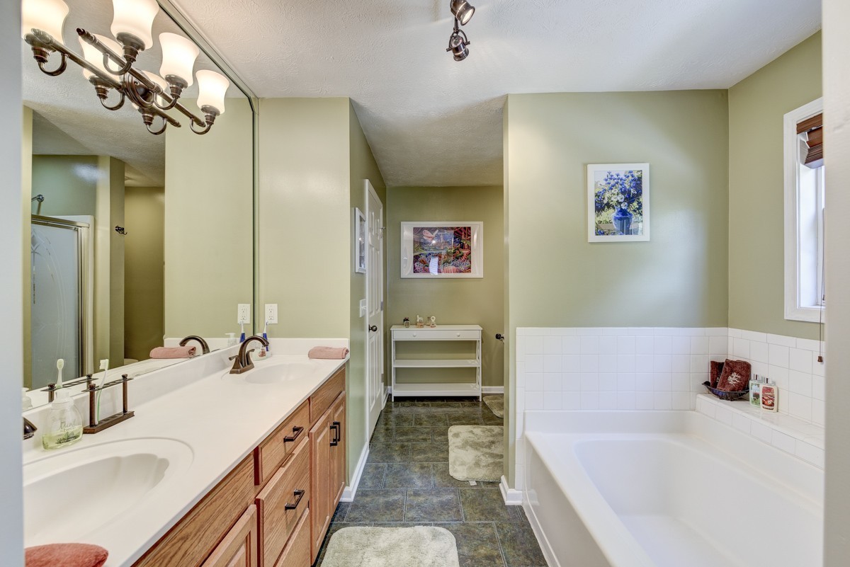 3011 Tyree Springs Road Hendersonville, TN 37075 - Photo 17 of 43 a bathroom with a tub sink and mirror