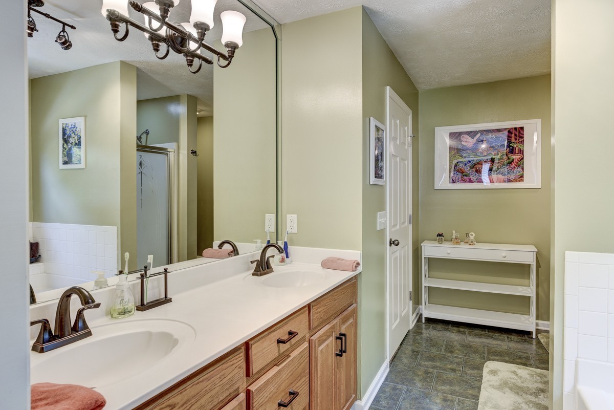 3011 Tyree Springs Road Hendersonville, TN 37075 - Photo 18 of 43 a bathroom with a sink double vanity granite tub and shower