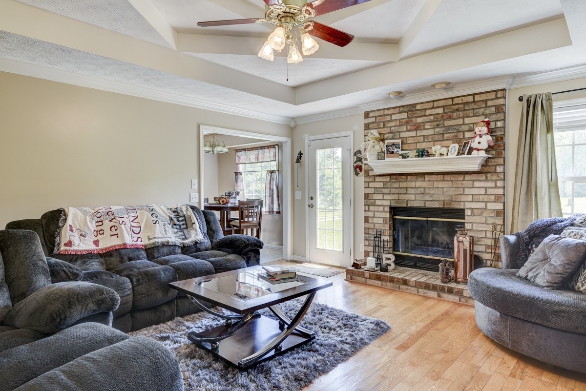 3011 Tyree Springs Road Hendersonville, TN 37075 - Photo 3 of 43 a living room with furniture a fireplace and a chandelier