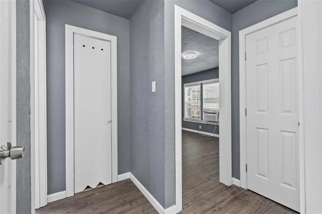 a view of a hallway with wooden floor