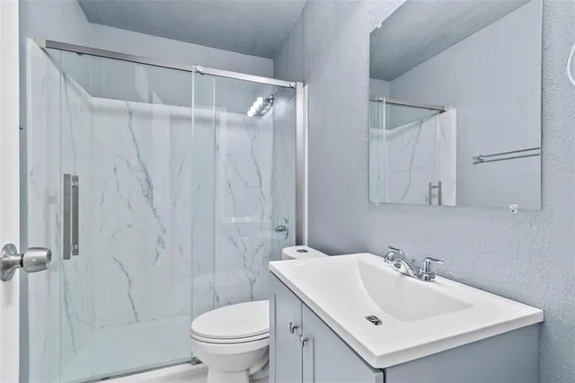 a bathroom with a sink toilet and shower