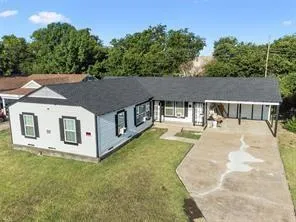 an aerial view of a house with swimming pool and sitting area