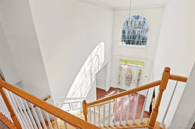 a view of entryway with wooden floor and stairs