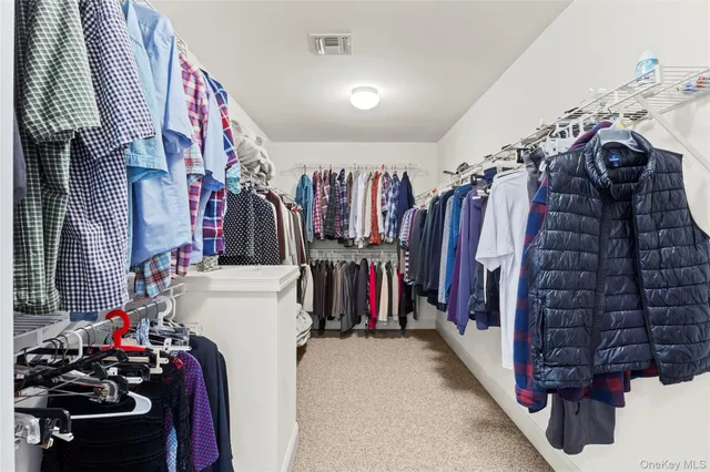 a bedroom with a bed and a dresser in it