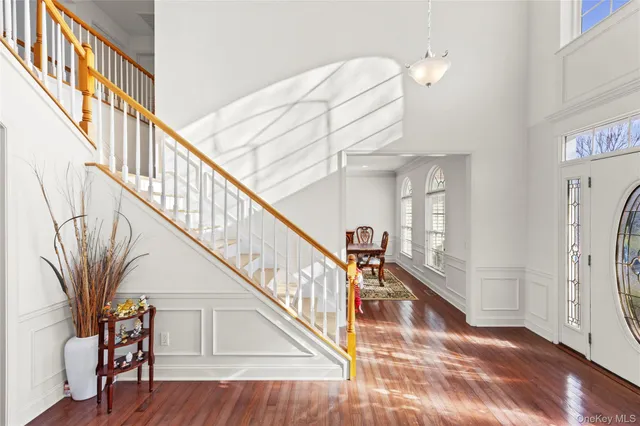 a view of entryway and hall with wooden floor