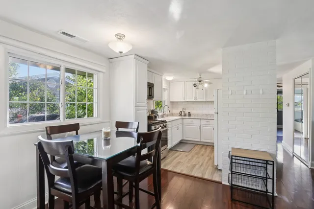 a view of a dining room with furniture window and wooden floor