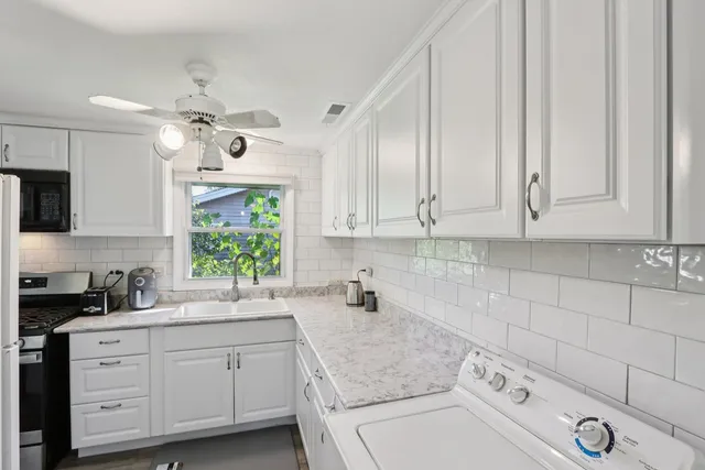 a kitchen with appliances cabinets and a sink