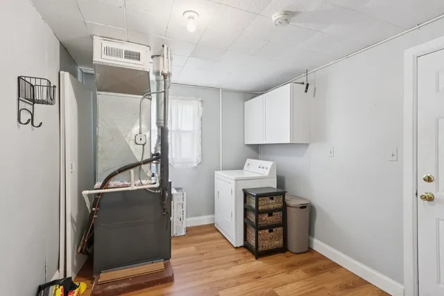 a view of a kitchen with fridge and wooden floor