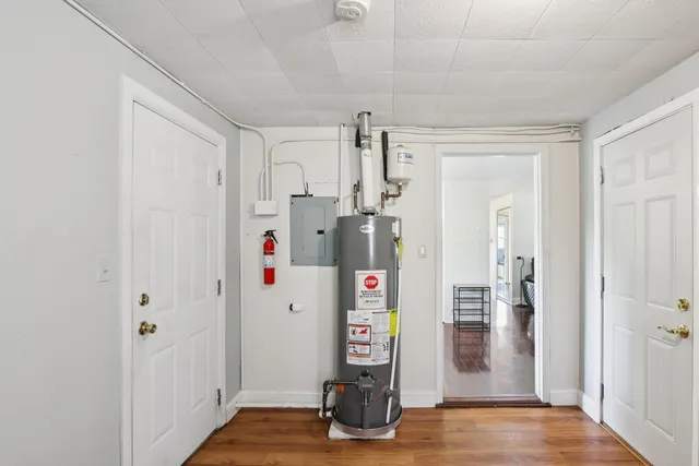 a view of room with wooden floor and refrigerator