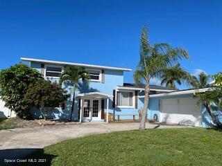 1034 Bali Road Cocoa Beach, FL 32931 - Photo 1 of 40 front view of a house with a yard