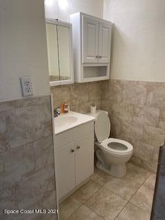 1034 Bali Road Cocoa Beach, FL 32931 - Photo 16 of 40 a bathroom with a toilet sink and mirror