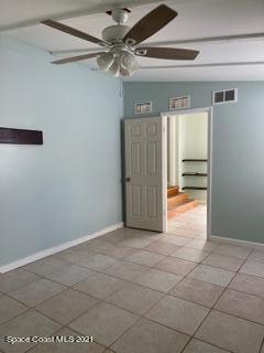 1034 Bali Road Cocoa Beach, FL 32931 - Photo 19 of 40 a view of a livingroom with an empty space and a ceiling fan