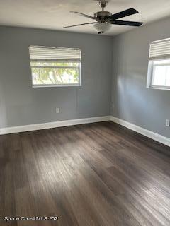 1034 Bali Road Cocoa Beach, FL 32931 - Photo 22 of 40 an empty room with wooden floor and windows