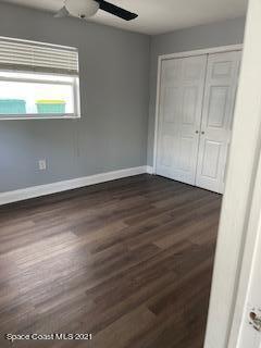 1034 Bali Road Cocoa Beach, FL 32931 - Photo 23 of 40 a view of an empty room with wooden floor and a window