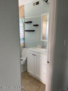 1034 Bali Road Cocoa Beach, FL 32931 - Photo 34 of 40 a bathroom with a sink toilet and mirror