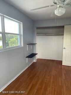 1034 Bali Road Cocoa Beach, FL 32931 - Photo 37 of 40 a view of empty room with wooden floor and fan