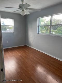1034 Bali Road Cocoa Beach, FL 32931 - Photo 38 of 40 a view of an empty room with wooden floor and a window