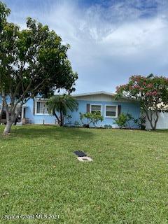 1034 Bali Road Cocoa Beach, FL 32931 - Photo 7 of 40 a front view of a house with a garden